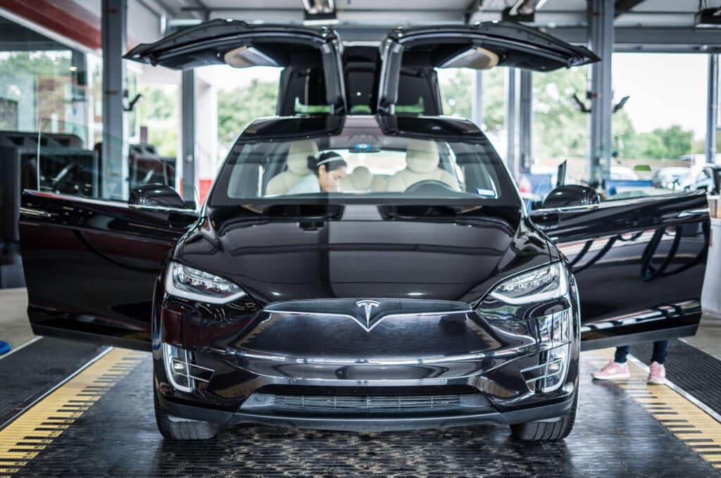 Tesla Model X parked at the Tesla factory in China, showcasing the innovative design and manufacturing environment.