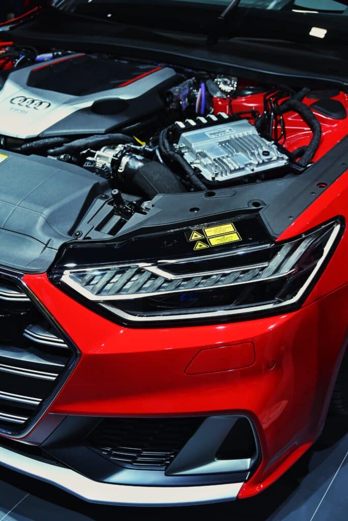A detailed view of the engine bay showcasing the components of a red Audi car.
