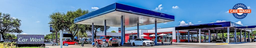 A gas station featuring a blue and white building, prominently displaying fuel pumps and signage.