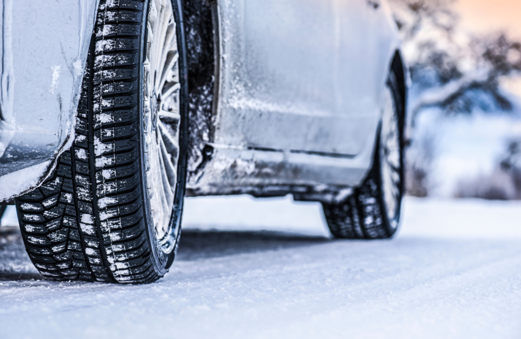 A close-up of winter tires showcasing their tread, emphasizing safety for vehicles in snowy conditions.